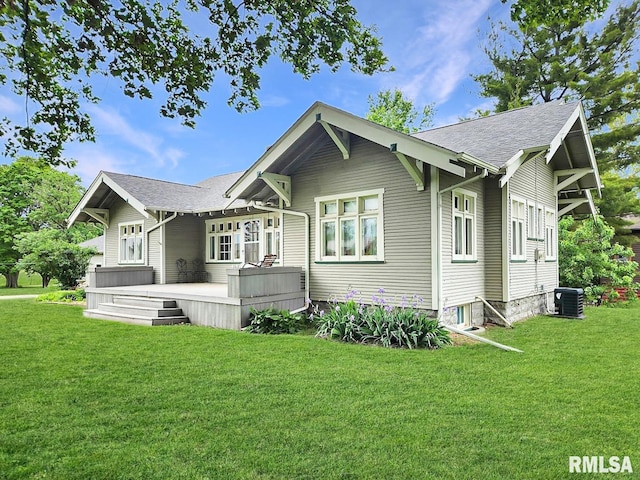 418 W Clinton St, Toulon, IL 61483 - view of front of home with central AC unit, a front yard, a deck, and a shingled roof