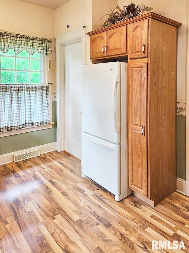 418 W Clinton St, Toulon, IL 61483 - kitchen with freestanding refrigerator, light wood-style flooring, and baseboards