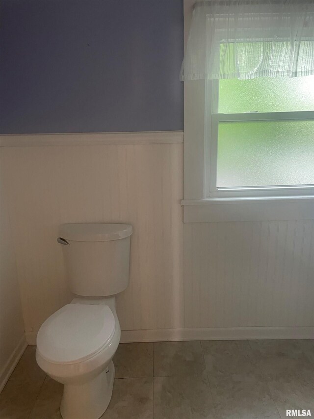 623 S Randolph St, Macomb, IL 61455 - bathroom with baseboards, wainscoting, toilet, and tile patterned flooring
