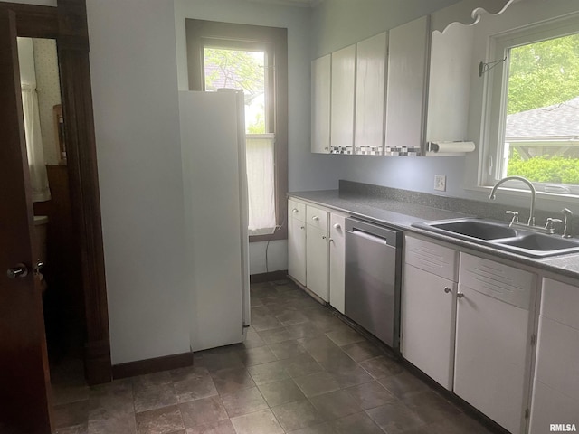 623 S Randolph St, Macomb, IL 61455 - kitchen with dishwasher, a sink, freestanding refrigerator, and white cabinets