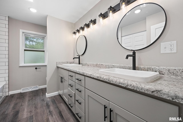 208 W Graze Ave, Dunlap, IL 61525 - full bath with double vanity, wood finished floors, baseboards, and recessed lighting