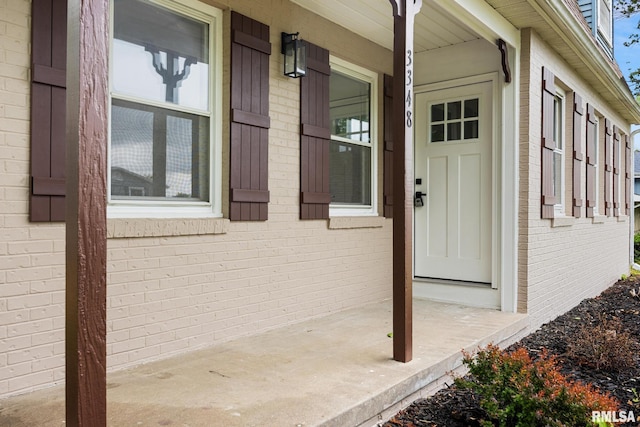 3348 W Lisa Ln, Peoria, IL 61615 - property entrance featuring covered porch and brick siding