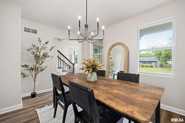 3348 W Lisa Ln, Peoria, IL 61615 - dining room with baseboards, a chandelier, dark wood-style flooring, and stairs