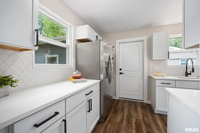 3348 W Lisa Ln, Peoria, IL 61615 - kitchen featuring a sink, stainless steel fridge with ice dispenser, backsplash, white cabinets, and dark wood-style flooring