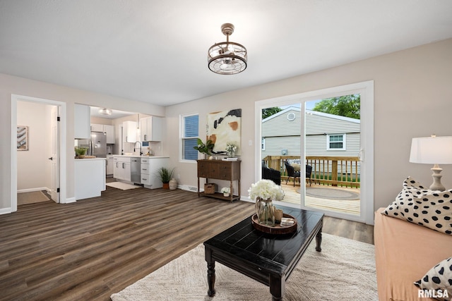 3348 W Lisa Ln, Peoria, IL 61615 - living area featuring baseboards, dark wood finished floors, and a chandelier