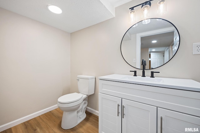 3348 W Lisa Ln, Peoria, IL 61615 - bathroom featuring toilet, wood finished floors, baseboards, and vanity