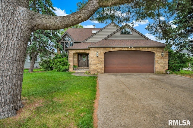 1220 S Main St, Morton, IL 61550 - english style home with stone siding, concrete driveway, roof with shingles, and a front lawn