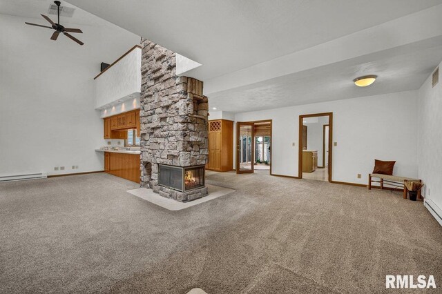1220 S Main St, Morton, IL 61550 - unfurnished living room featuring light colored carpet, baseboards, a ceiling fan, a baseboard radiator, and a towering ceiling