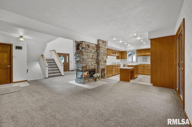 1220 S Main St, Morton, IL 61550 - living area with stairs, light colored carpet, and a fireplace