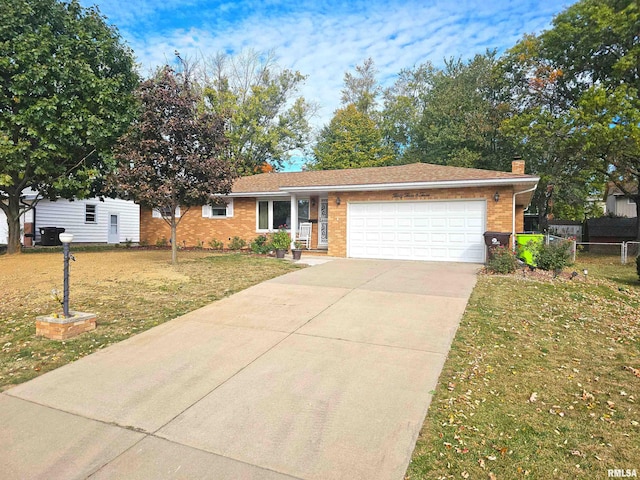 3303 W Chartwell Rd, Peoria, IL 61614 - single story home with an attached garage, concrete driveway, a chimney, and brick siding