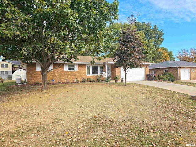 3303 W Chartwell Rd, Peoria, IL 61614 - single story home featuring driveway, an attached garage, brick siding, and cooling unit