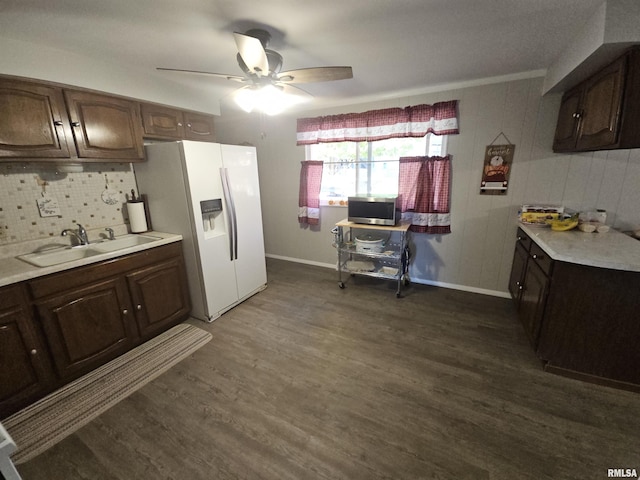 3303 W Chartwell Rd, Peoria, IL 61614 - kitchen with a sink, white fridge with ice dispenser, a ceiling fan, light countertops, and dark wood finished floors