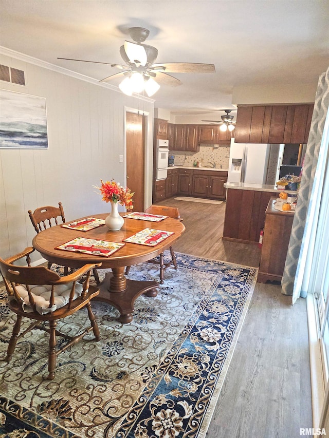 3303 W Chartwell Rd, Peoria, IL 61614 - dining room featuring ceiling fan, light wood finished floors, and crown molding