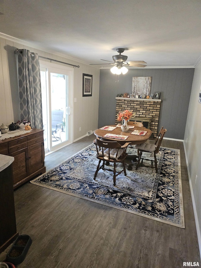 3303 W Chartwell Rd, Peoria, IL 61614 - dining area with ornamental molding, wood finished floors, baseboards, a ceiling fan, and a fireplace