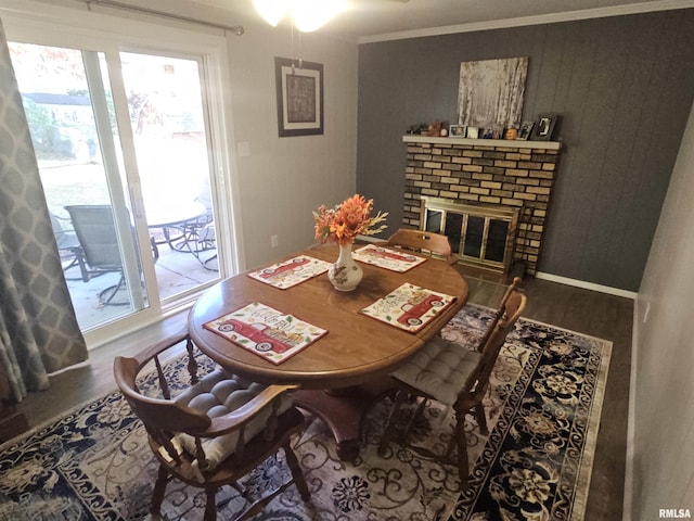 3303 W Chartwell Rd, Peoria, IL 61614 - dining area featuring wood finished floors, a fireplace, and ornamental molding