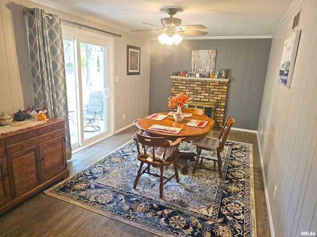 3303 W Chartwell Rd, Peoria, IL 61614 - dining room featuring ornamental molding, wood finished floors, baseboards, ceiling fan, and a fireplace