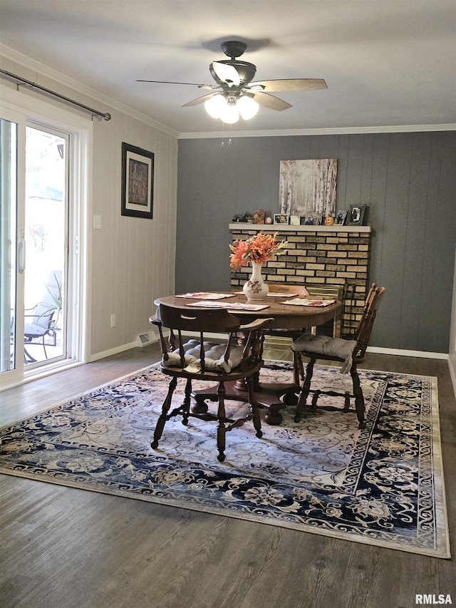 3303 W Chartwell Rd, Peoria, IL 61614 - dining area with wood finished floors, ornamental molding, a ceiling fan, and baseboards