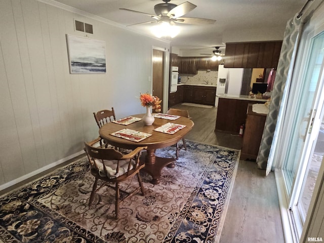 3303 W Chartwell Rd, Peoria, IL 61614 - dining room featuring light wood-type flooring, ceiling fan, and crown molding