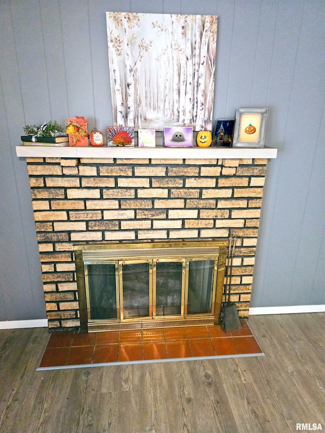 3303 W Chartwell Rd, Peoria, IL 61614 - detailed view of a fireplace, baseboards, wood finished floors, and a decorative wall