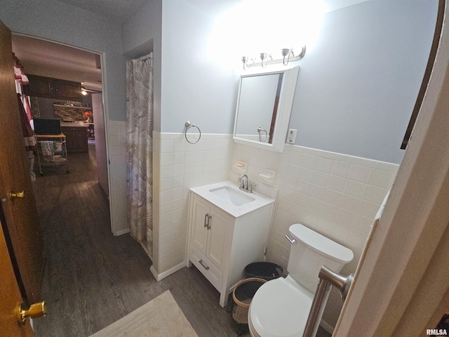 3303 W Chartwell Rd, Peoria, IL 61614 - bathroom with tile walls, wood finished floors, vanity, wainscoting, and toilet