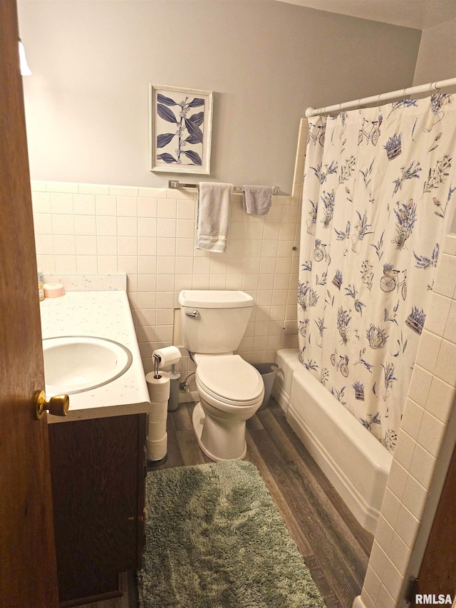 3303 W Chartwell Rd, Peoria, IL 61614 - bathroom featuring wood finished floors, vanity, toilet, tile walls, and shower / bath combo with shower curtain