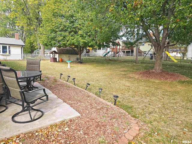 3303 W Chartwell Rd, Peoria, IL 61614 - view of yard featuring a playground, outdoor dining space, and a patio