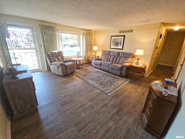 3303 W Chartwell Rd, Peoria, IL 61614 - living area with dark wood-type flooring, baseboards, and a textured ceiling