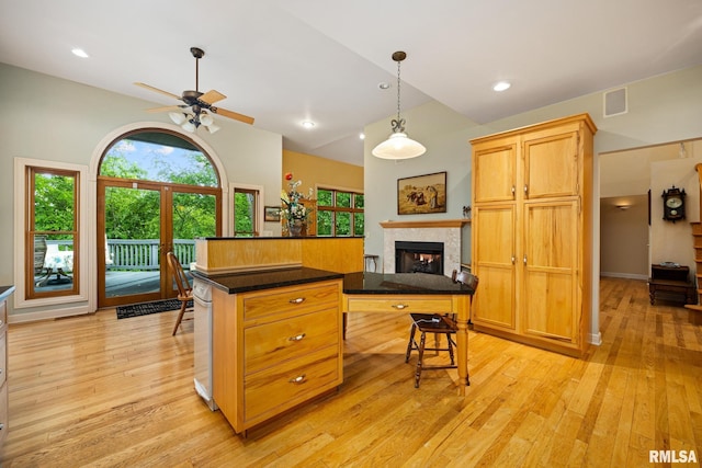 131 Lakeside Pl, Dahinda, IL 61428 - kitchen with ceiling fan, light wood-type flooring, a glass covered fireplace, dark countertops, and lofted ceiling