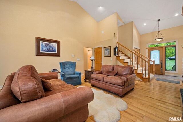 131 Lakeside Pl, Dahinda, IL 61428 - living room with stairway, light wood-style floors, high vaulted ceiling, and recessed lighting