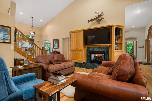 131 Lakeside Pl, Dahinda, IL 61428 - living area with light wood-style flooring, stairway, a fireplace, high vaulted ceiling, and recessed lighting