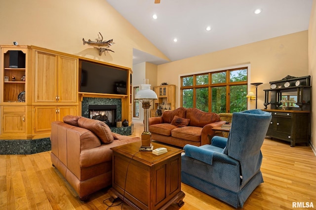 131 Lakeside Pl, Dahinda, IL 61428 - living area featuring light wood-type flooring, high vaulted ceiling, recessed lighting, and a high end fireplace