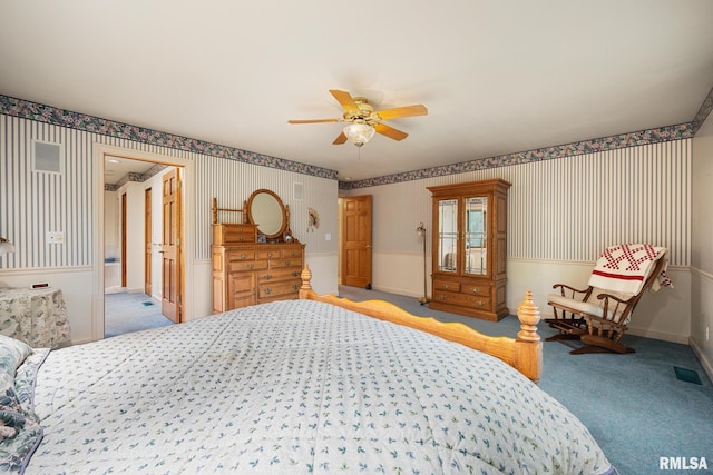131 Lakeside Pl, Dahinda, IL 61428 - bedroom with wallpapered walls, carpet, wainscoting, and a ceiling fan