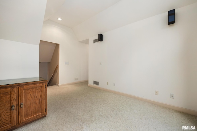 131 Lakeside Pl, Dahinda, IL 61428 - unfurnished room featuring light colored carpet, recessed lighting, vaulted ceiling, and baseboards