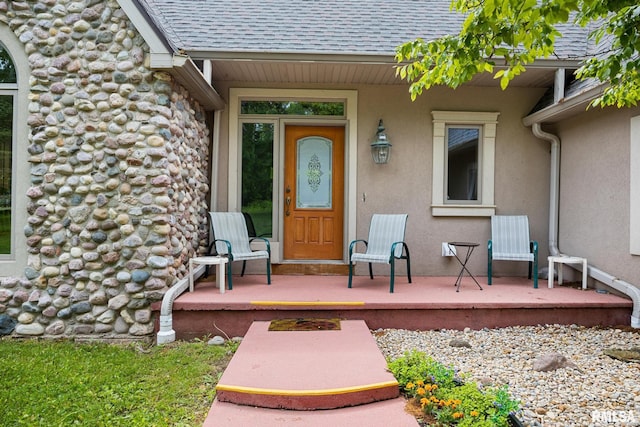 131 Lakeside Pl, Dahinda, IL 61428 - entrance to property featuring covered porch, roof with shingles, and stucco siding