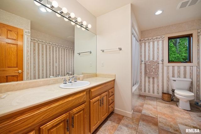 131 Lakeside Pl, Dahinda, IL 61428 - full bathroom with wallpapered walls, vanity, toilet, baseboards, and shower / bath combo