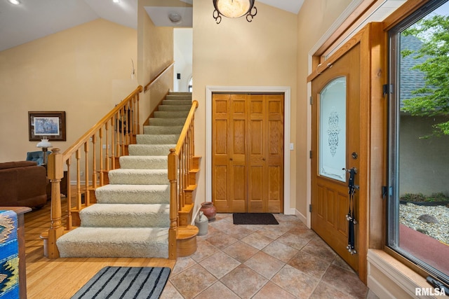 131 Lakeside Pl, Dahinda, IL 61428 - entrance foyer with stairway, high vaulted ceiling, and baseboards