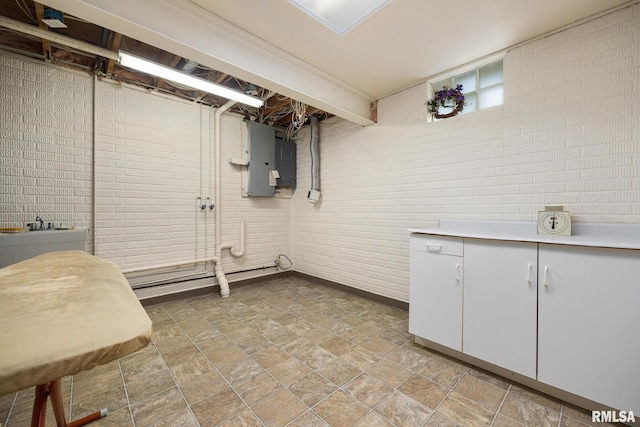 131 Lakeside Pl, Dahinda, IL 61428 - below grade area featuring brick wall, electric panel, and stone finish flooring