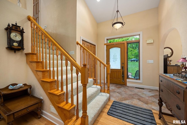 131 Lakeside Pl, Dahinda, IL 61428 - entryway featuring a high ceiling, arched walkways, baseboards, and stairway