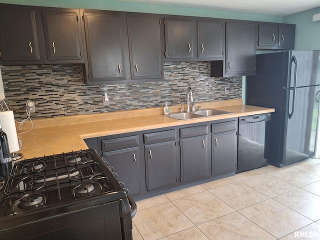 1907 Chicory Rd, Pekin, IL 61554 - kitchen featuring a sink, dishwasher, light countertops, light tile patterned floors, and black range with gas stovetop