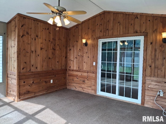 1907 Chicory Rd, Pekin, IL 61554 - empty room featuring wooden walls, carpet floors, lofted ceiling, and a ceiling fan