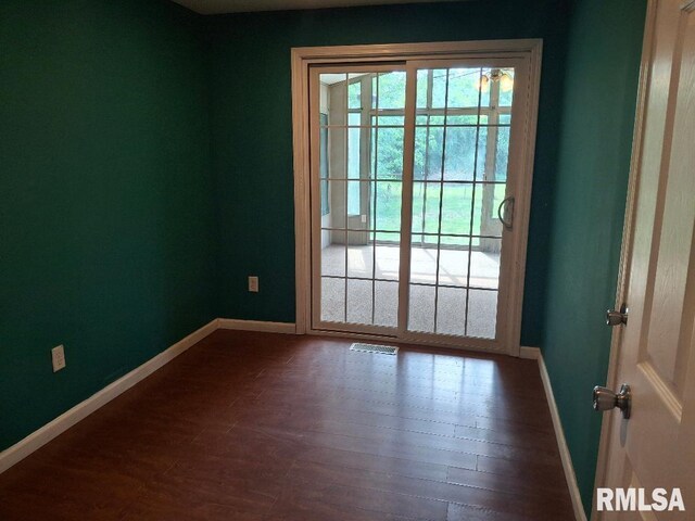 1907 Chicory Rd, Pekin, IL 61554 - spare room with healthy amount of natural light, baseboards, and dark wood-type flooring