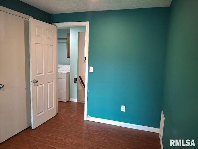 1907 Chicory Rd, Pekin, IL 61554 - unfurnished bedroom with washer / dryer, dark wood-style floors, a textured ceiling, and baseboards