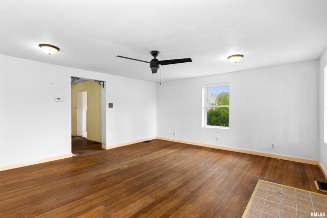 507 E Main St, Bryant, IL 61519 - unfurnished room with a ceiling fan, wood-type flooring, and baseboards