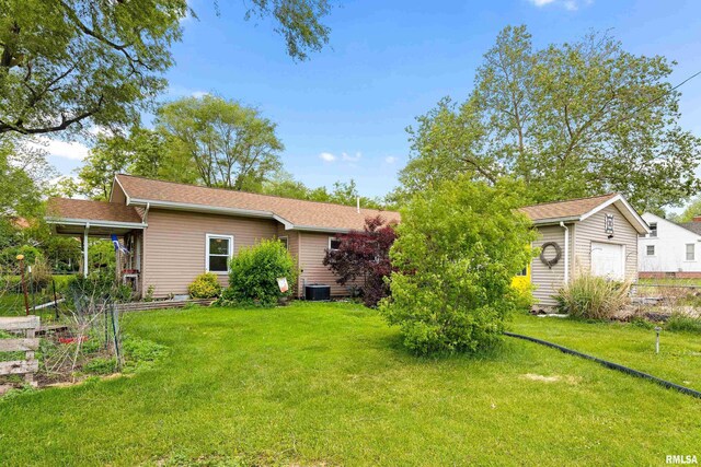 507 E Main St, Bryant, IL 61519 - back of house featuring a yard and central AC unit