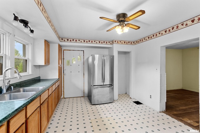 507 E Main St, Bryant, IL 61519 - kitchen with freestanding refrigerator, a sink, dark countertops, ceiling fan, and light flooring