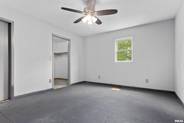 507 E Main St, Bryant, IL 61519 - unfurnished bedroom featuring baseboards, a ceiling fan, and concrete flooring