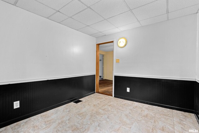 507 E Main St, Bryant, IL 61519 - spare room with wainscoting and a paneled ceiling