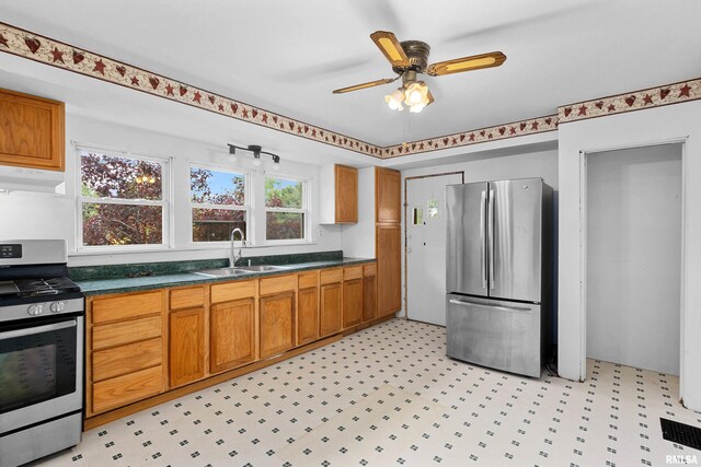 507 E Main St, Bryant, IL 61519 - kitchen featuring stainless steel appliances, a sink, extractor fan, light floors, and dark countertops