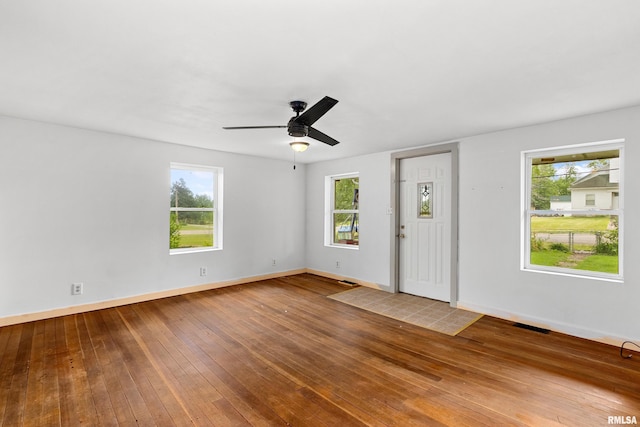 507 E Main St, Bryant, IL 61519 - foyer featuring healthy amount of natural light, hardwood / wood-style floors, a ceiling fan, and baseboards