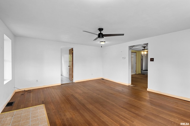 507 E Main St, Bryant, IL 61519 - spare room with ceiling fan, wood-type flooring, and baseboards